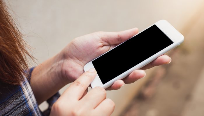 telefon komórkowy trzymany w dłoniach